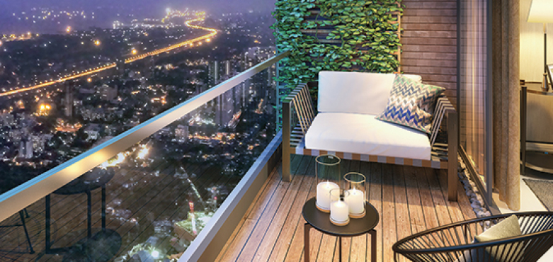 Balcony overlooking Pune's night skyline, vibrant city lights shining from a 3 BHK apartment in Pune.